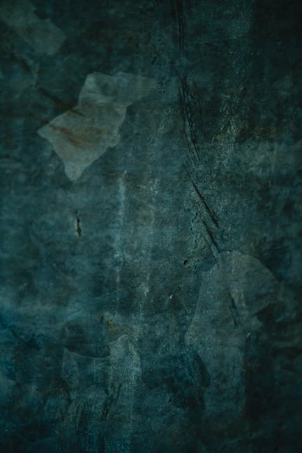 Dark grunge texture with vintage and rough details, showcasing a weathered surface.